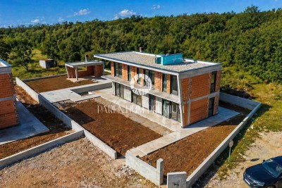 A modern villa with a swimming pool and a spacious garden - under construction
